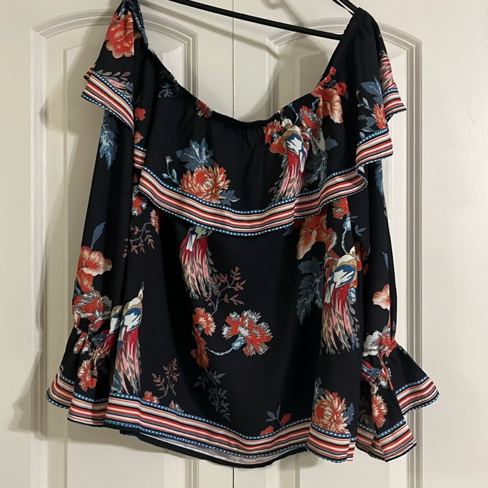 Off the shoulder, black top with Flowy sleeves.